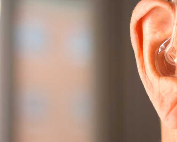 man wearing modern digital hearing aid