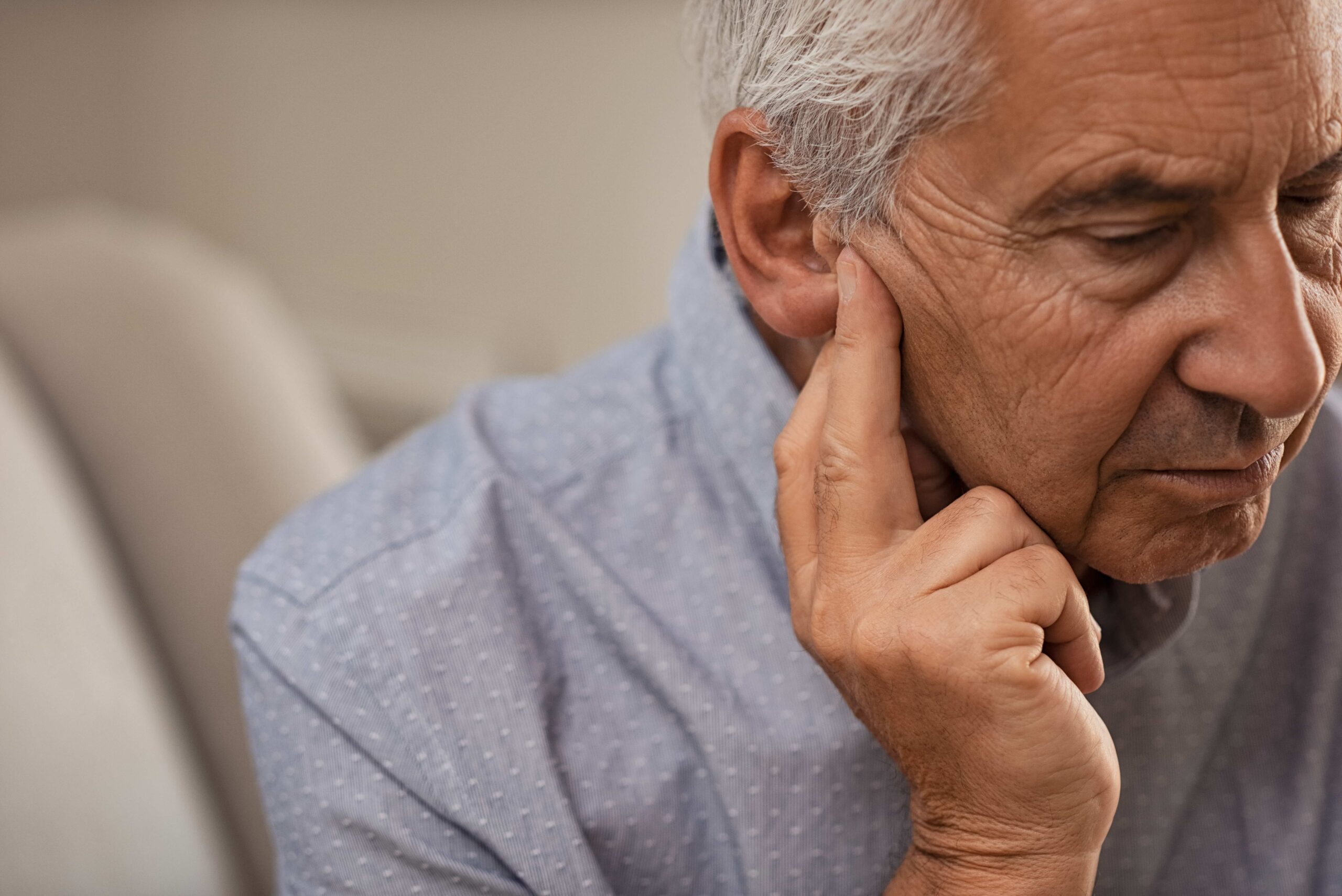 man with symptoms of hearing loss due to stress.